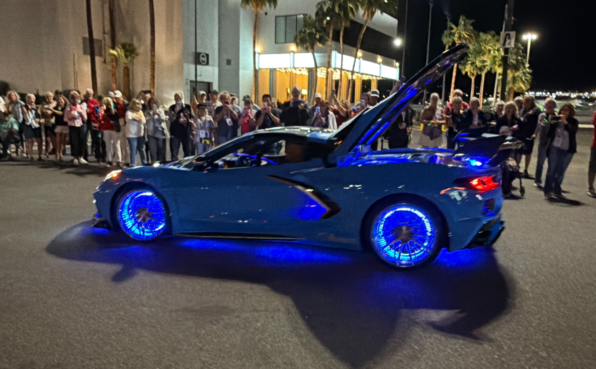 Customized blue Chevrolet Corvette at evening club event